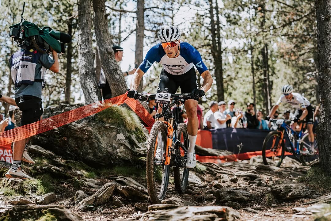 Carter Woods navigating a technical rock garden section through trees